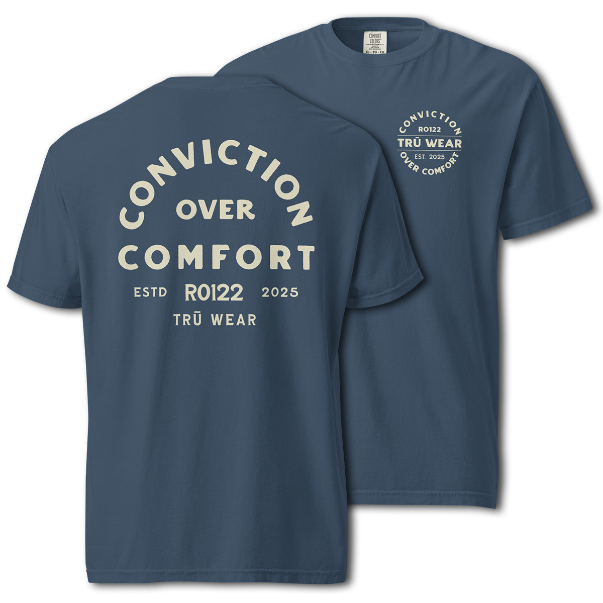 TRŪ Wear Conviction Over Comfort garment-dyed heavyweight tee in Midnight blue, front and back views. Back print reads 'Conviction Over Comfort' in cream arch typography with verse code RO122 and TRŪ Wear below. Front chest features circular badge mark. Comfort Colors 1717 blank. Christian men's Scripture tee.